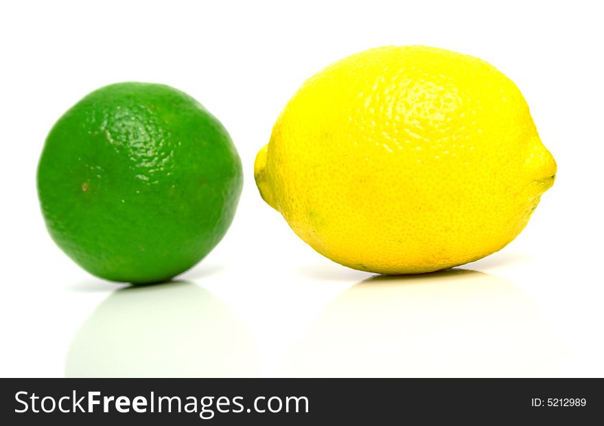 Lemon and lime on white. Isolation, shallow DOF.