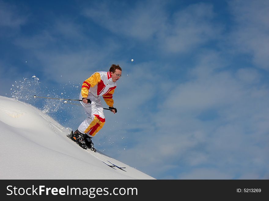 Bright winter day. The mountain skier moves down downhill. Bright winter day. The mountain skier moves down downhill.