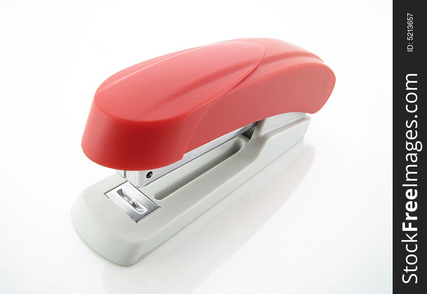 Red office stapler on a white background