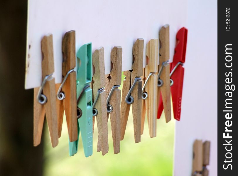Multi-coloured clothespins weighing on a cord one after another