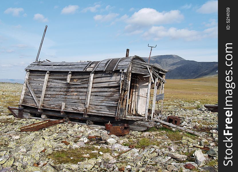 Photo. The old, abandoned wooden wagon in the mountains. Home.