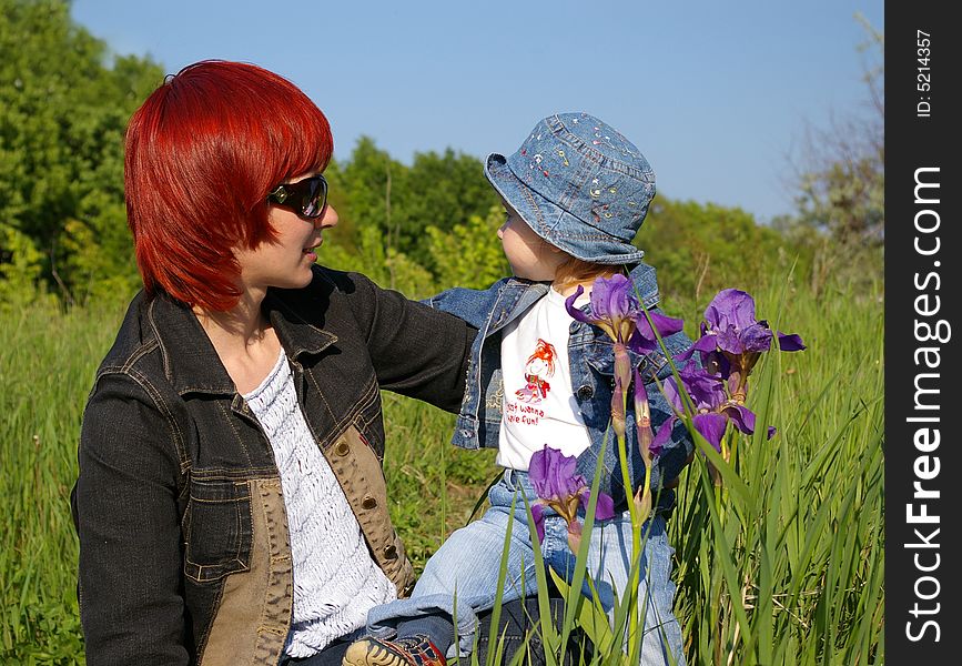 The little girl and her mum on a grass. The little girl and her mum on a grass