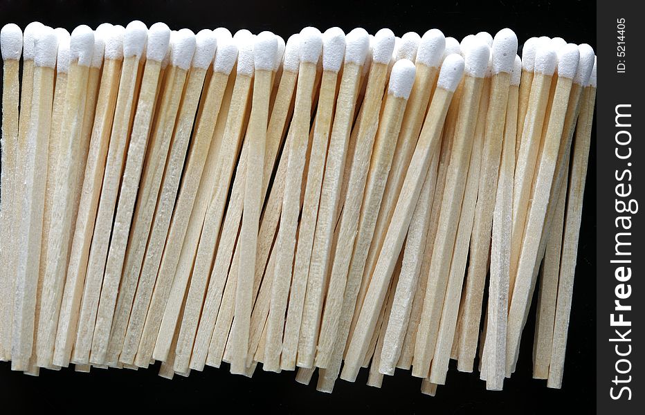 A row of matches on black background