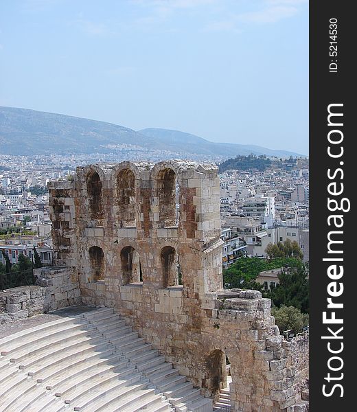 Ancient ruins, amphitheater at the acropolis and panorama of Athens in the background, Greece. Ancient ruins, amphitheater at the acropolis and panorama of Athens in the background, Greece.