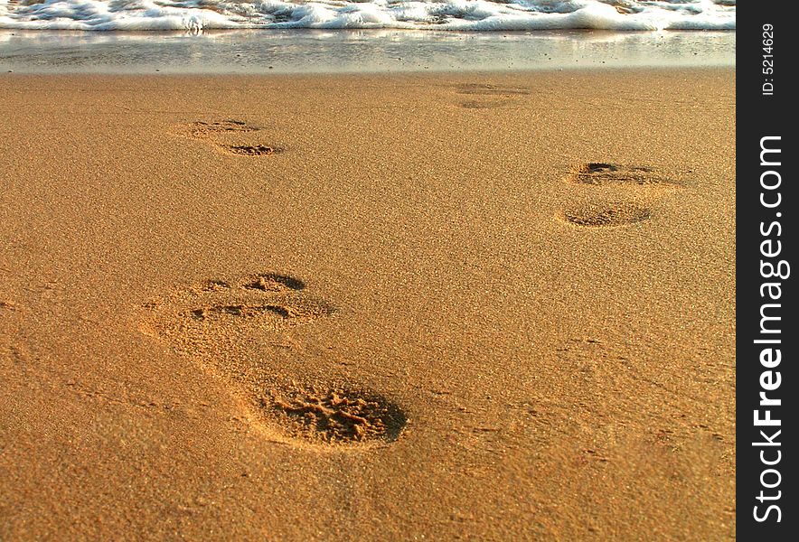 Close up on footsteps on beach