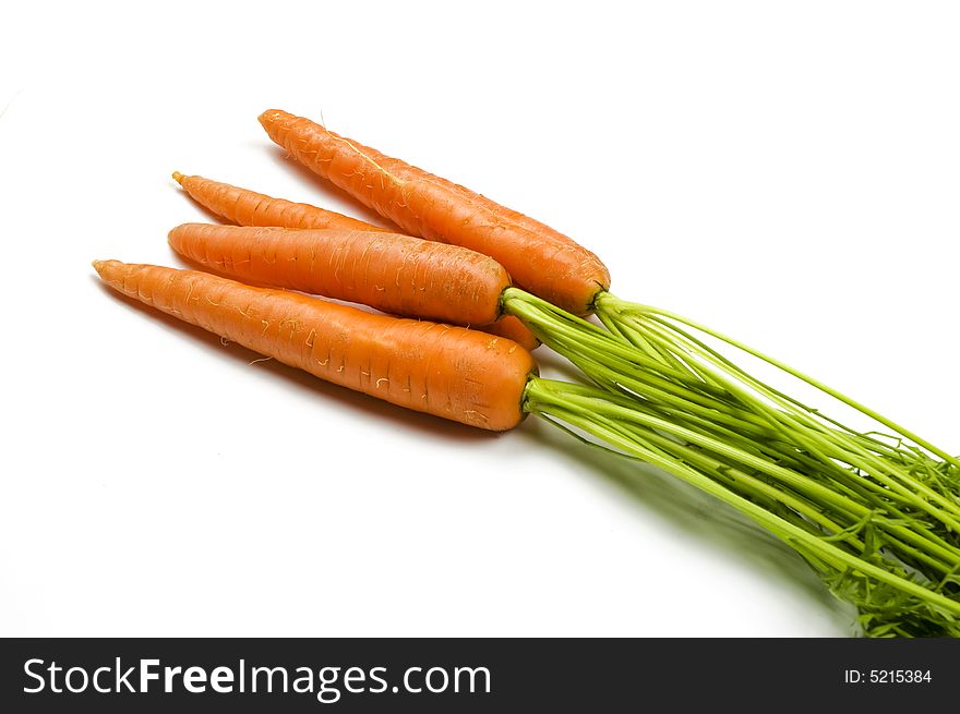 Fresh and ripe bunch of orange carrots isolated on white background. Fresh and ripe bunch of orange carrots isolated on white background