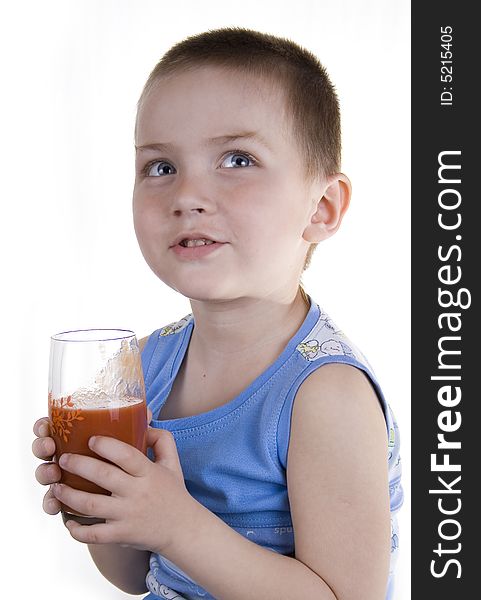 The child drinks tomato juice on a white background