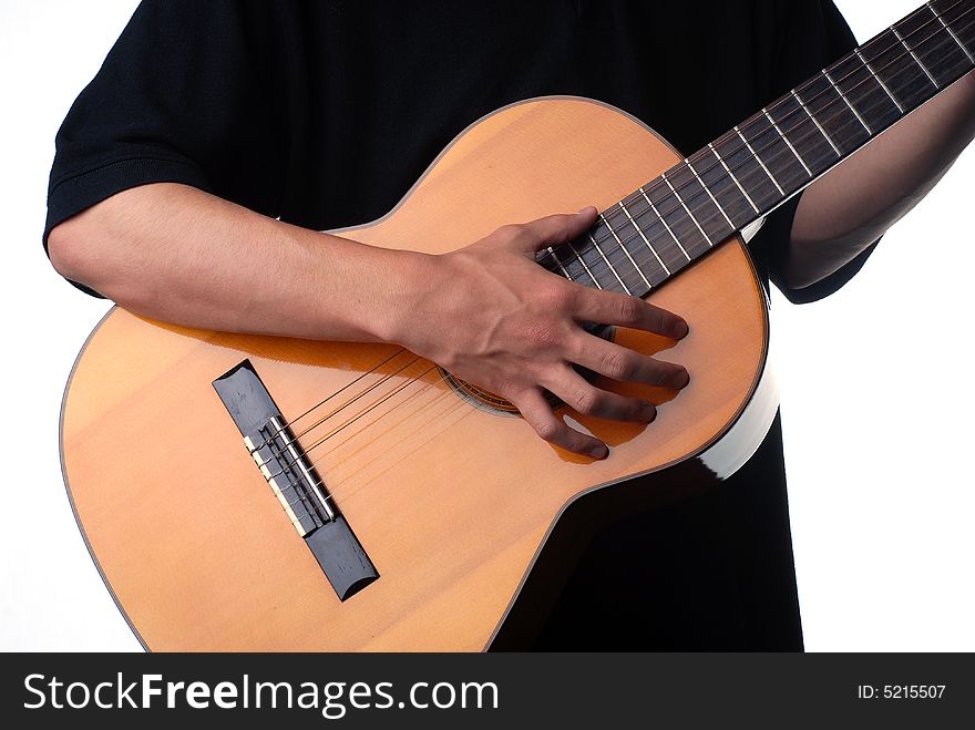 Shot of a male hand strumming guitar strings. Shot of a male hand strumming guitar strings