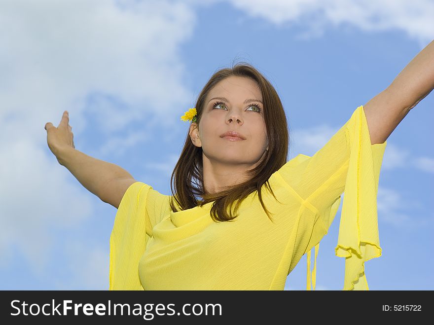 Portrait of a smiling young woman with open hand.