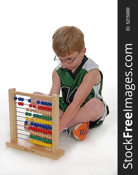 Young boy learning math on an abacus. Young boy learning math on an abacus