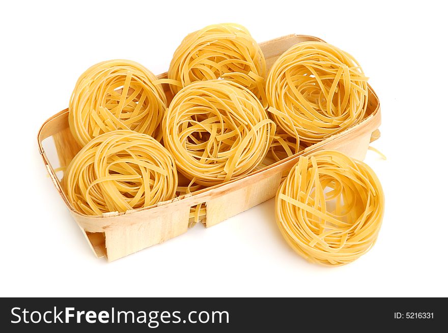 Italian pasta tagliatelle in basket isolated on white. Italian pasta tagliatelle in basket isolated on white