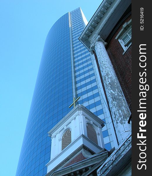 Church steeple near a modern office tower in Lower Manhattan.