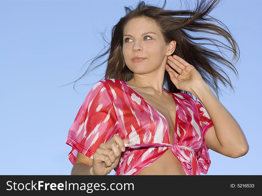 Attractive Brunette Woman On Sky Background
