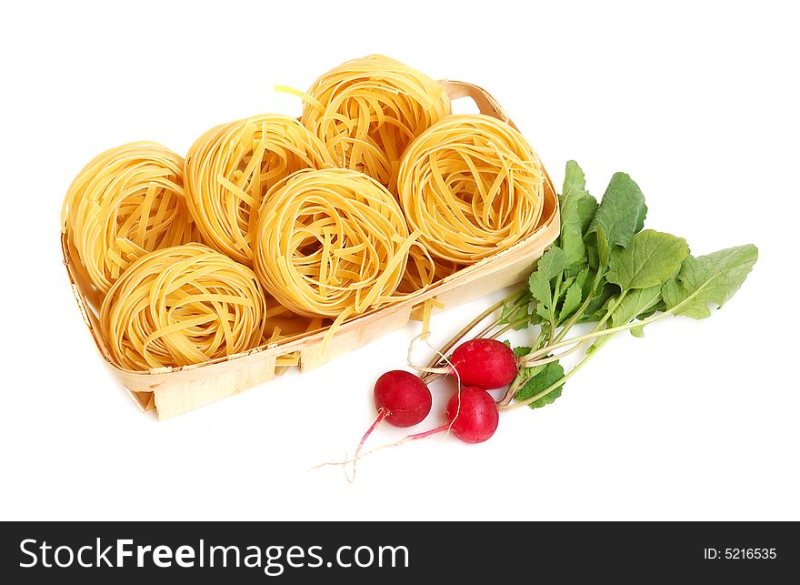 Italian pasta tagliatelle and radish in basket isolated on white. Italian pasta tagliatelle and radish in basket isolated on white