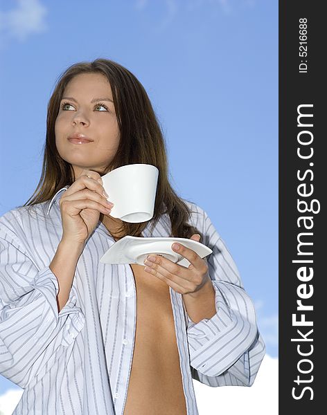 Young woman relaxing, drinking coffee