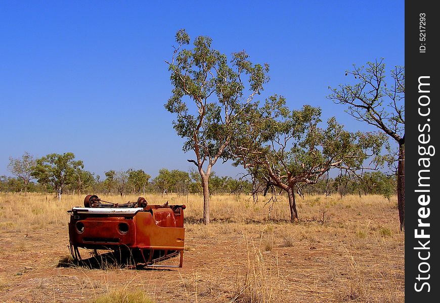 A rusty Volkswagen Type 2 lying upside down in the Outback in Australia. A rusty Volkswagen Type 2 lying upside down in the Outback in Australia