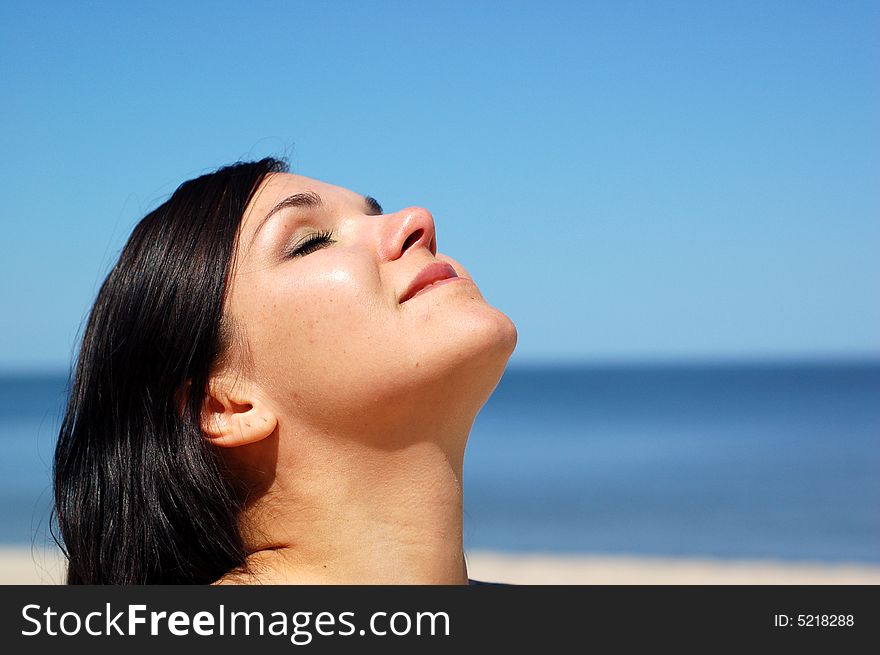 Attractive woman jumping on the sunny beach. Attractive woman jumping on the sunny beach