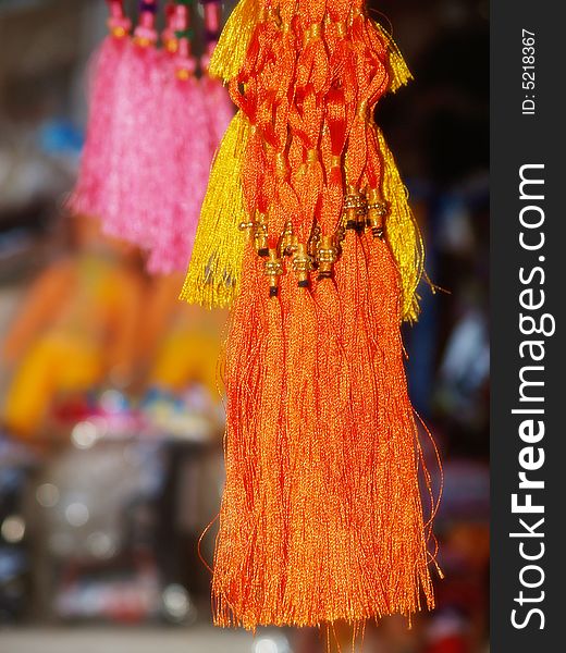 Bright ribbons and tassels hanging in different colors.