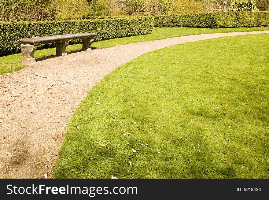 Bench and footpath in romantic garden