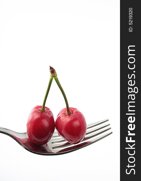 Two cherries on a fork