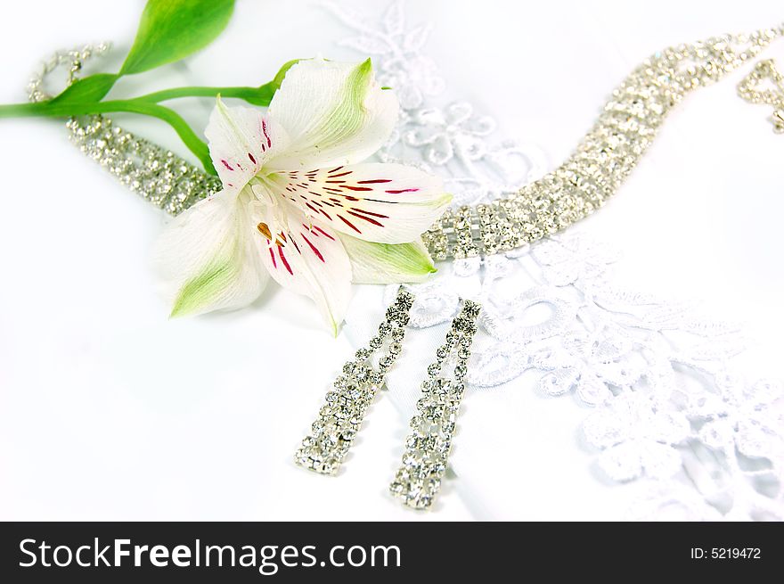 Wedding jewelery, laces, earrings and white flower. Wedding jewelery, laces, earrings and white flower