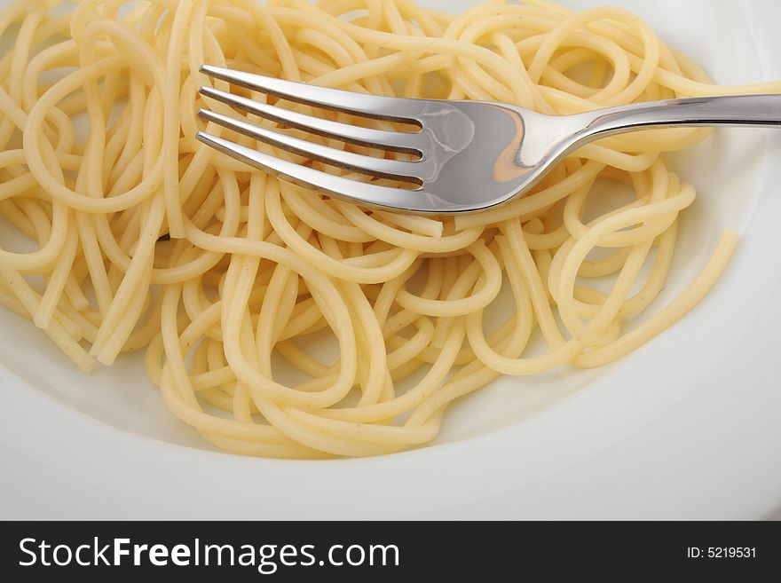 Spaghetti on a white plate with a fork. Spaghetti on a white plate with a fork