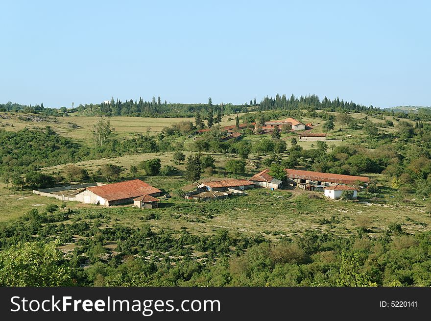 A rural landscape, rustic houses in green environment under blue sky, anatolia, turkey. A rural landscape, rustic houses in green environment under blue sky, anatolia, turkey