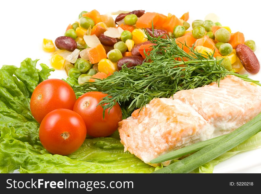 Stake from a salmon with vegetables on a plate