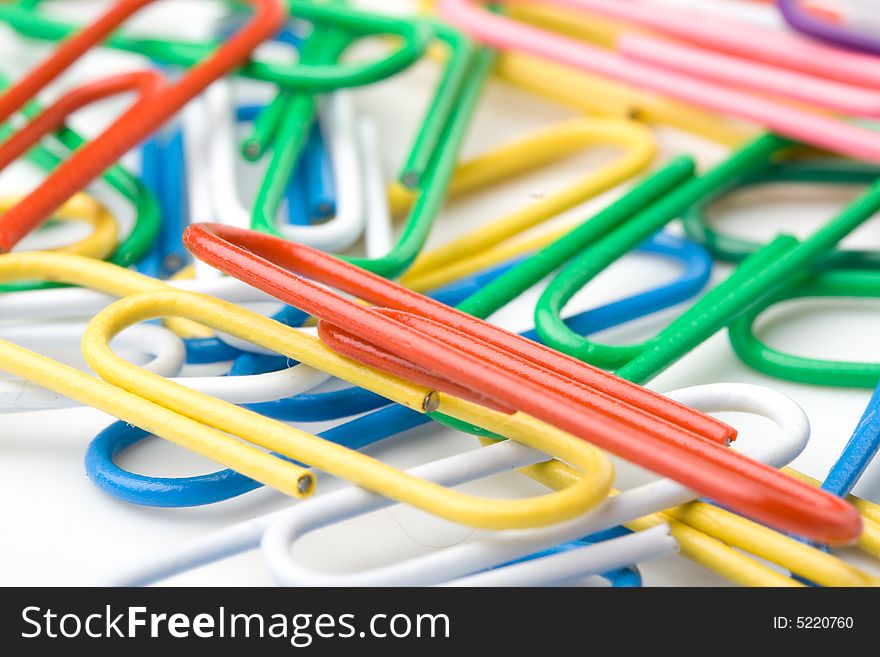 Colorful paper clips on a white background. Close up. Selective focus.