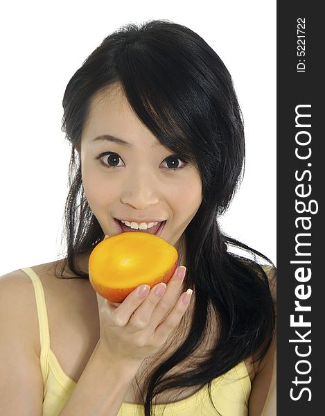 Pretty smiling woman with mango