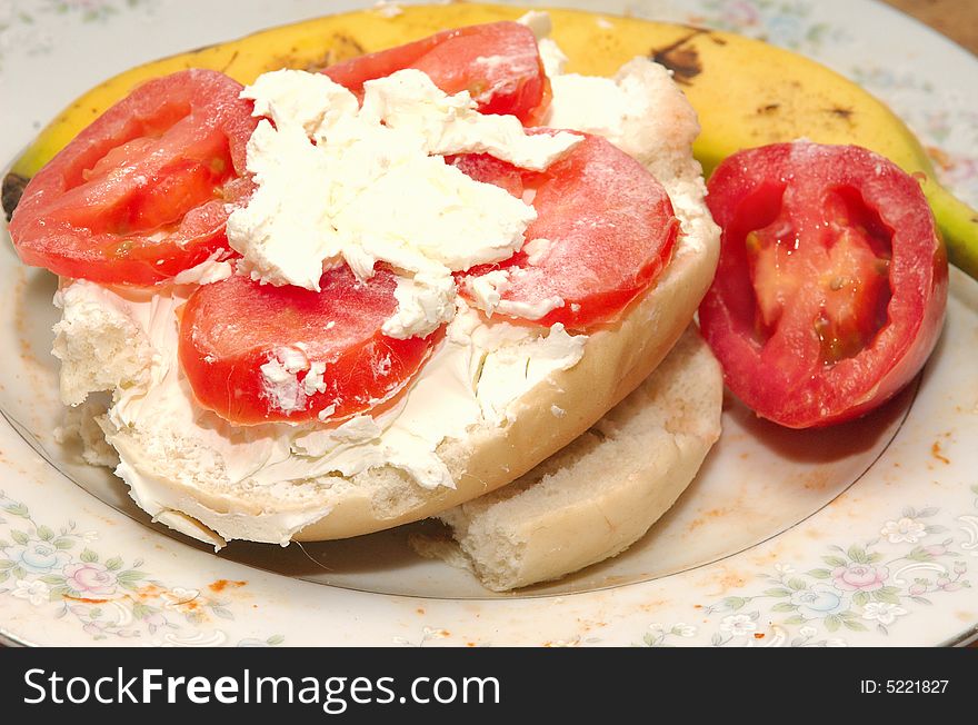 Bagel with creamcheese and tomato and banana, as a food product image with color. Bagel with creamcheese and tomato and banana, as a food product image with color