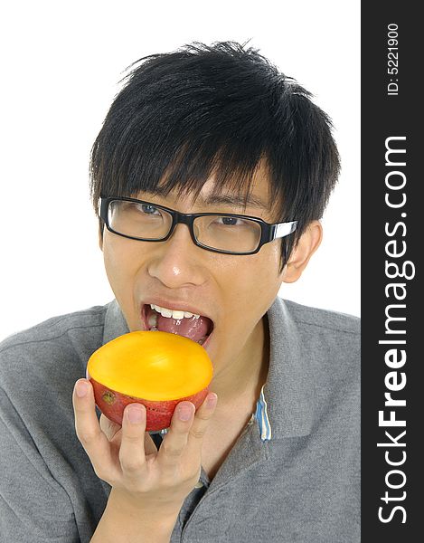 Young Asian boy eating fruit