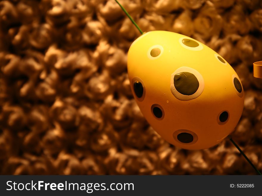A yellow egg over a brown background