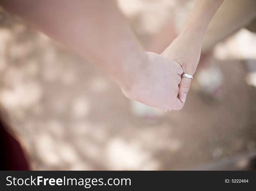 Young woman and young man are holding hands in love outside