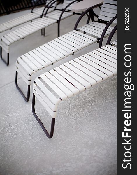 A group of pool chairs outside next to the pool in the summer