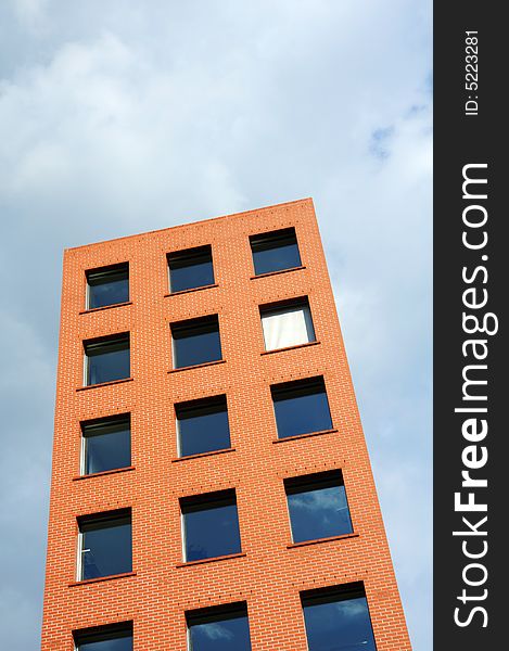 Orange building against sombre sky. Orange building against sombre sky