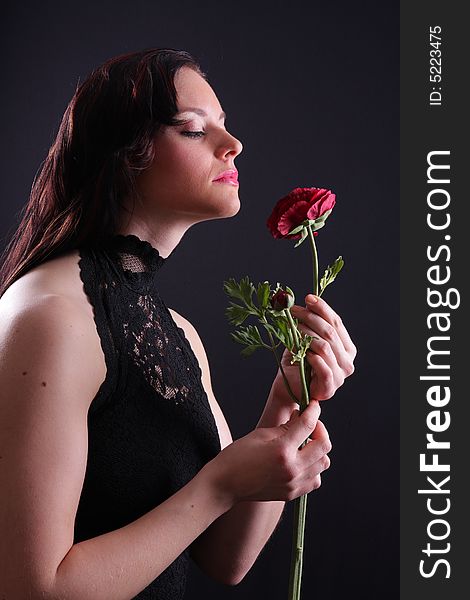 Young woman dressed in black holding a rose. Young woman dressed in black holding a rose