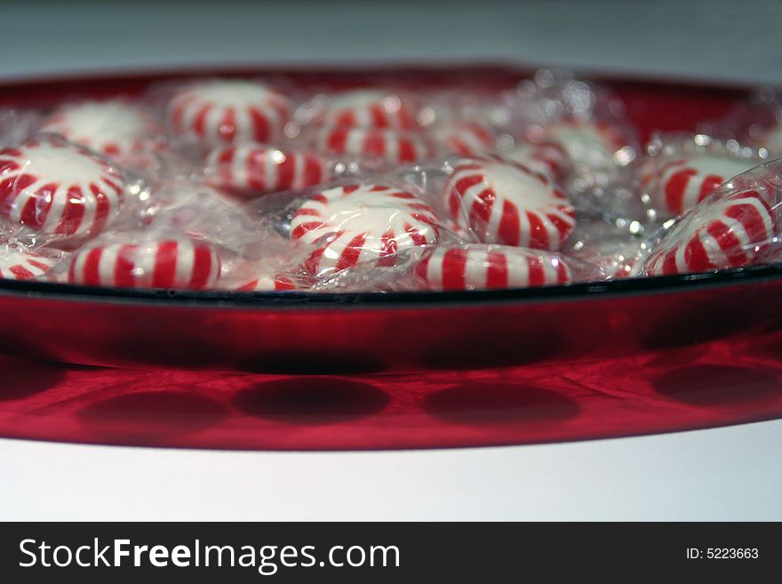 Red oblong bowl of peppermint candy. Red oblong bowl of peppermint candy