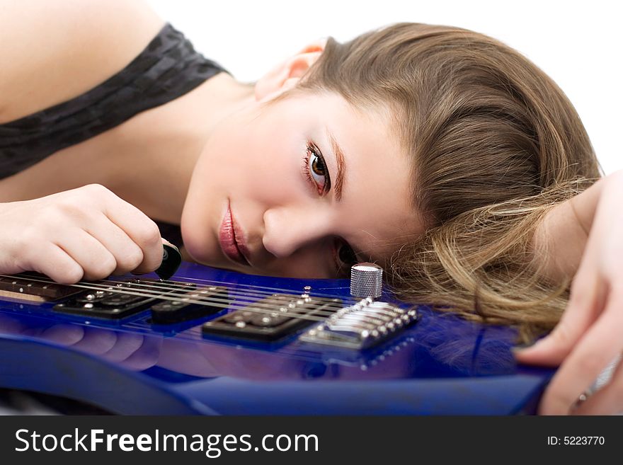 Lovely brunette with an electric guitar over white. Lovely brunette with an electric guitar over white