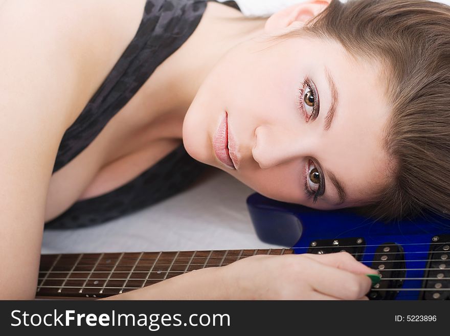 Lovely brunette with an electric guitar over white. Lovely brunette with an electric guitar over white