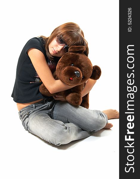 The girl with the teddy bear on a white background