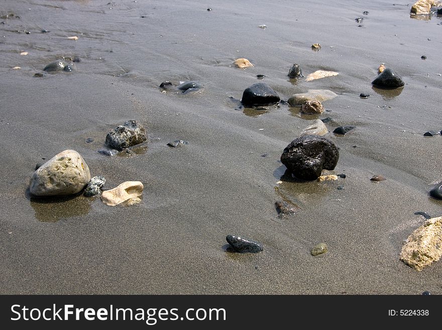 Stones on sand, coast, sea