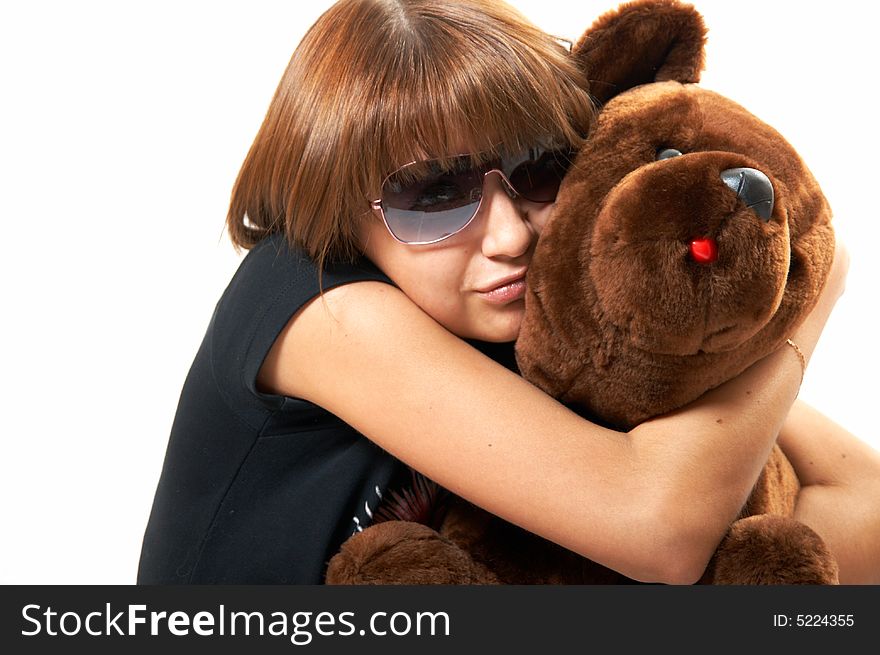 The girl with the teddy bear on a white background