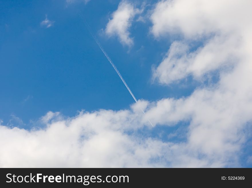 The dark blue sky in white clouds