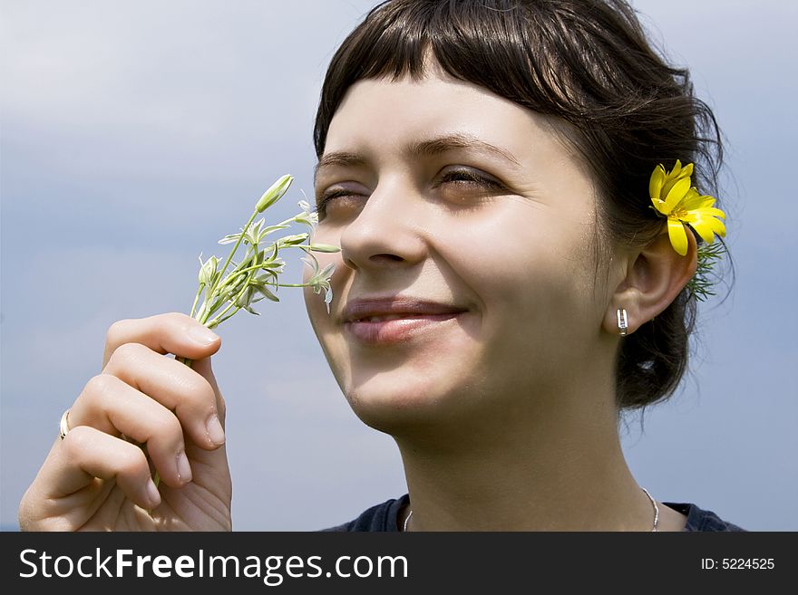 Young Girl Smelling Flowers