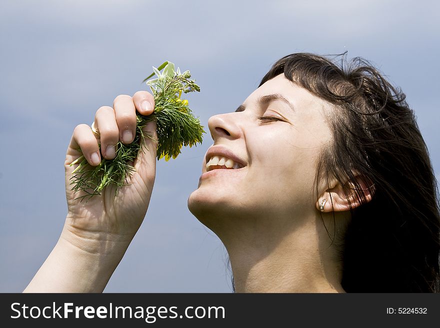 Young girl smelling wild flowers. Young girl smelling wild flowers