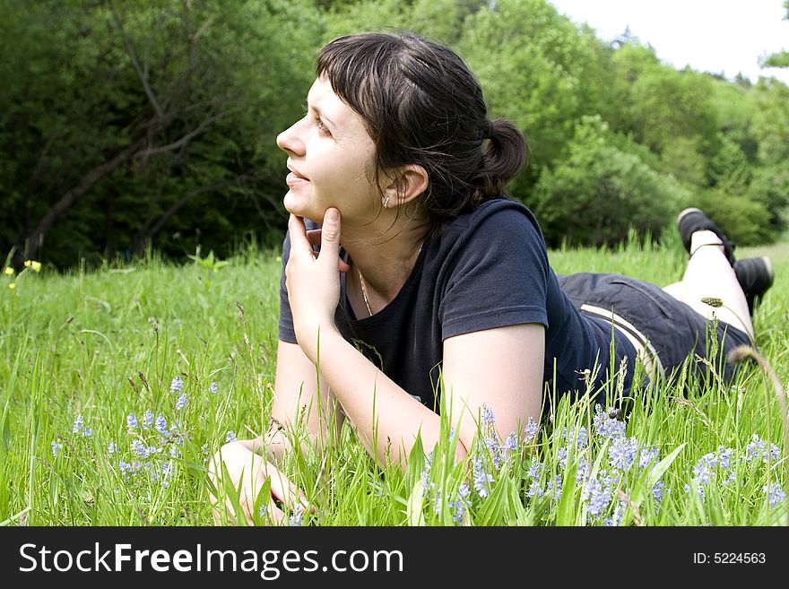 Young girl laying in grass