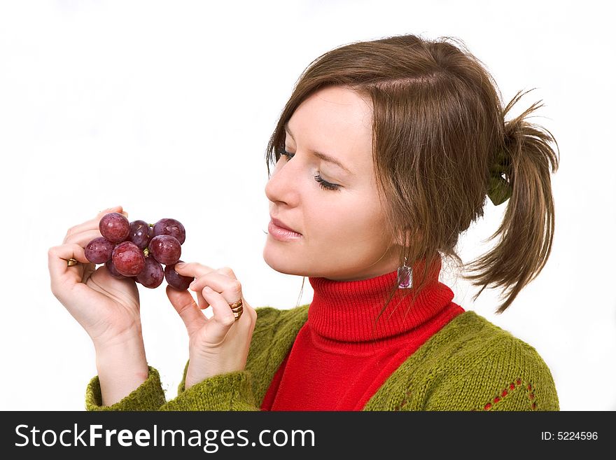 Young girl is holding grapes in the palm