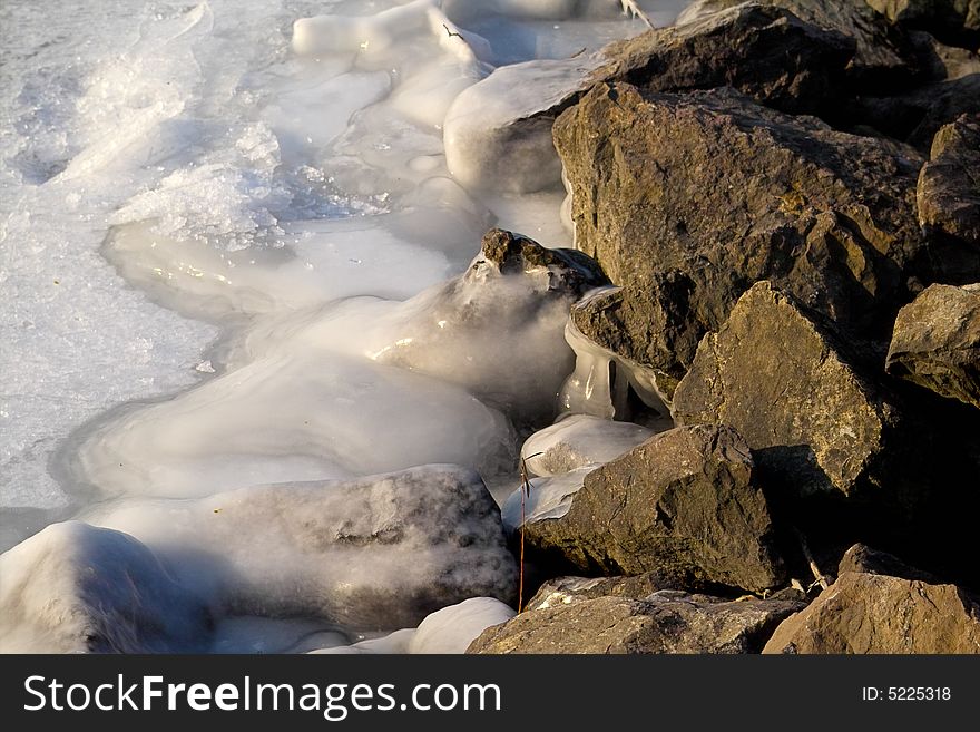A frozen rock at the riverside