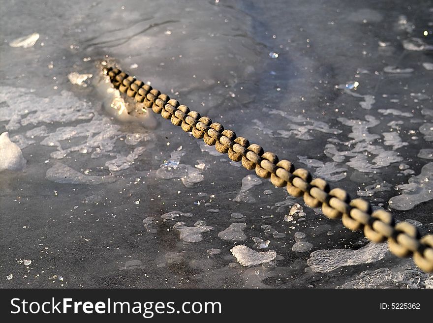 A chain breaking out of a frozen river. A chain breaking out of a frozen river